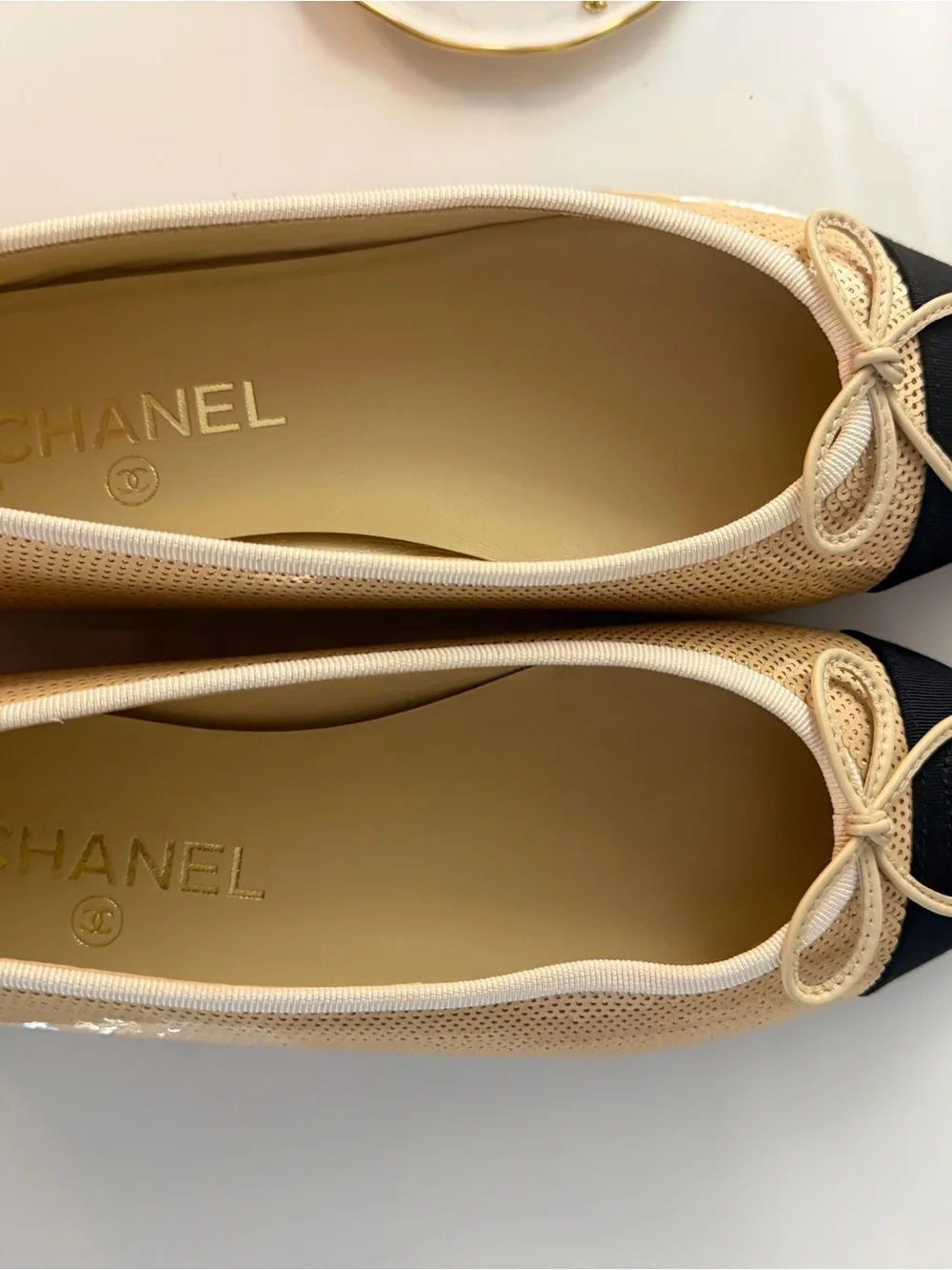CHANEL Beige and Black Cap-Toe Ballet Flats with Bow